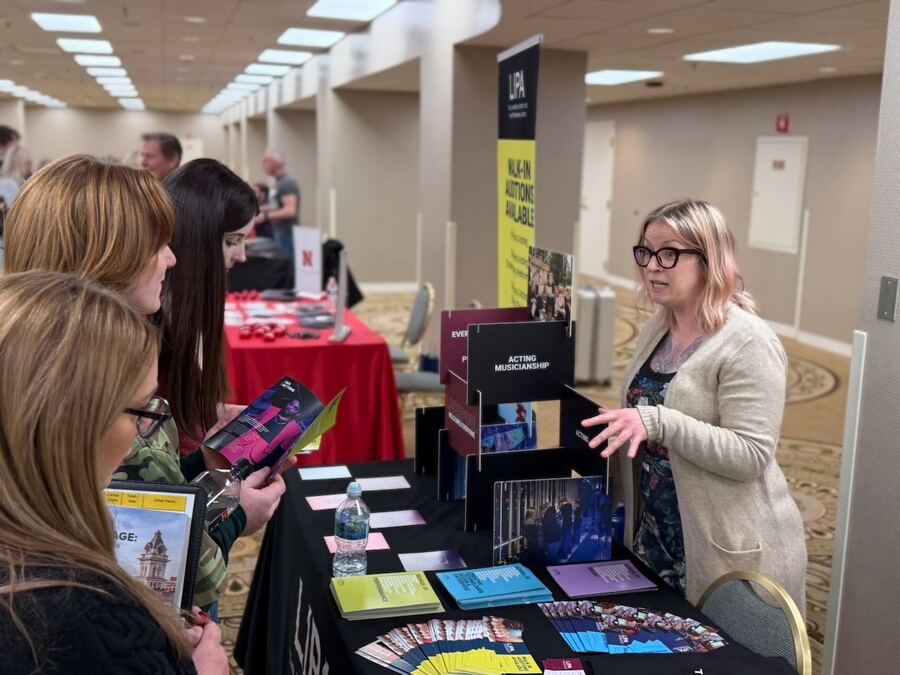 A student browsing brochures at the LIPA table