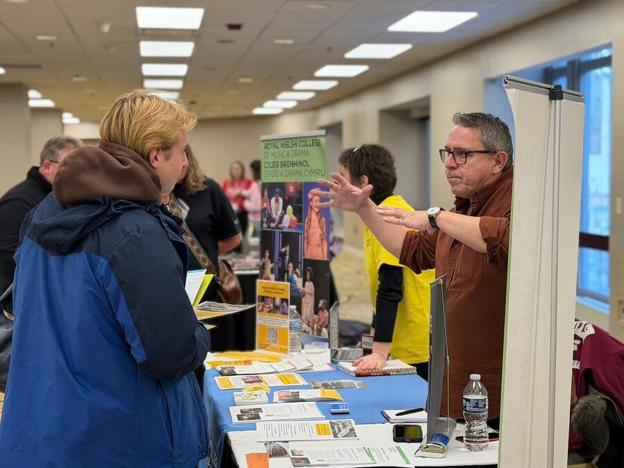 A representative explaining his program to a student